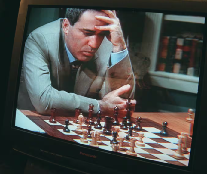 Garry Kasparov studies a chessboard with his hand against his forehead during the Deep Blue era